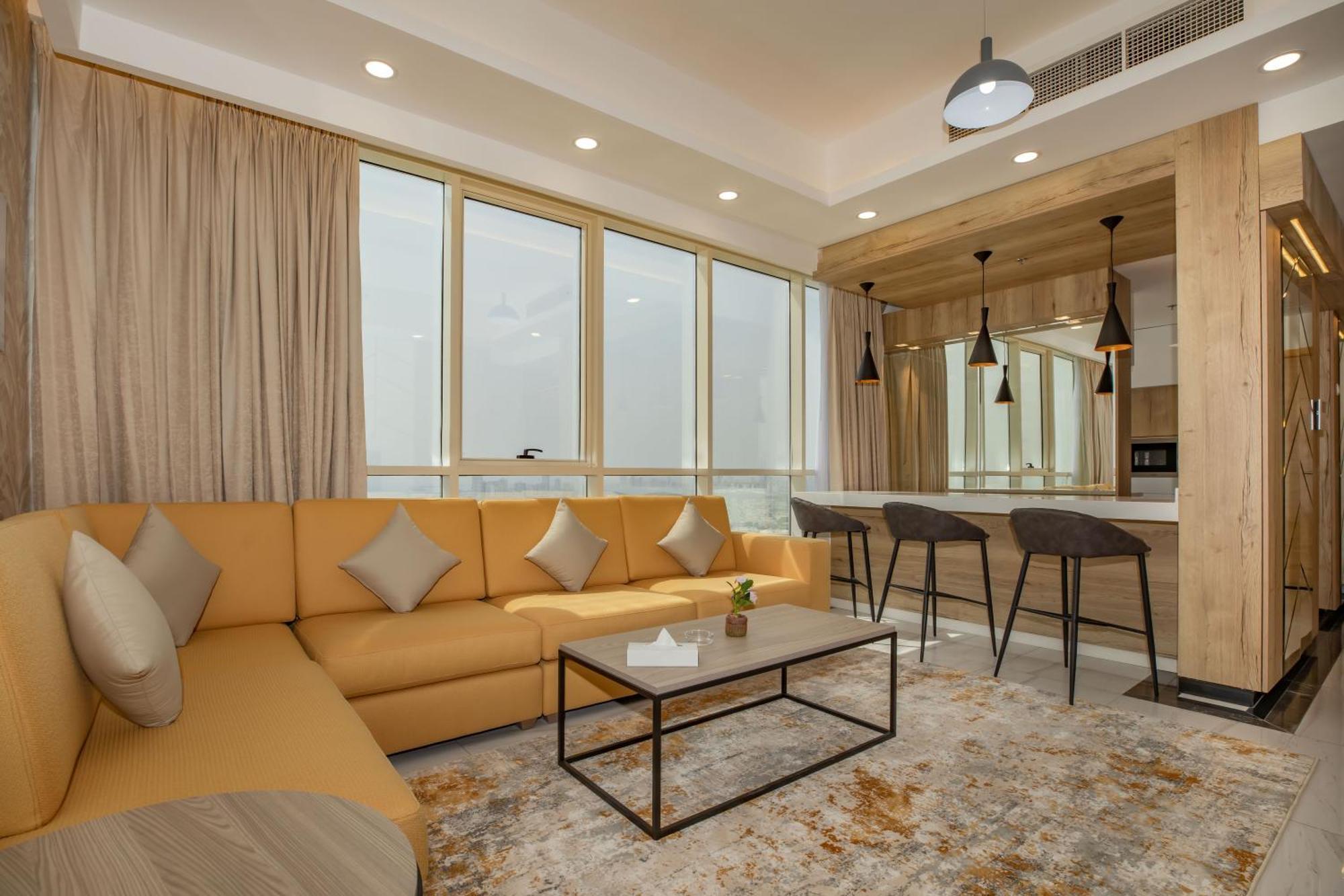 Platinum Coast Hotel Apartments Fujairah Room photo A living room in a suite at the hotel